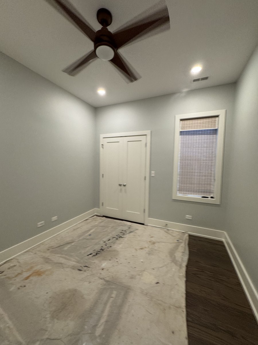 After painting: lighter bedroom walls with white trim in Chicago.